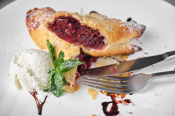Delicious cherry strudel dessert served with ice cream