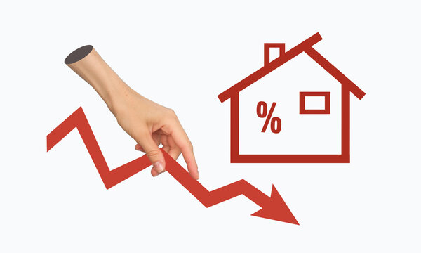 Hand holding red arrow down on house sign background concept of real estate price reduction discounts and great offer