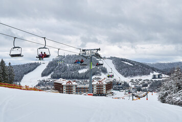 Naklejka premium View of a modern mountain ski resort with a chairlift.