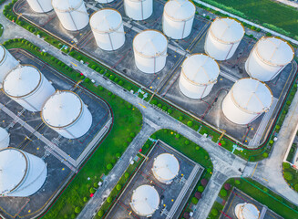 Aerial view of large white oil storage tanks with roads.