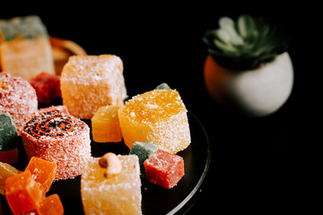 Delicious assortment of colorful Turkish delights arranged on a black background