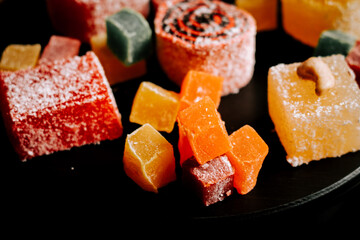 Enjoying colorful Turkish delights lokum at a festive gathering in a vibrant setting