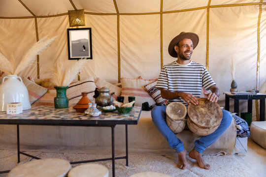 Musical moment in glamping haima with bongo and boho decor in Sahara