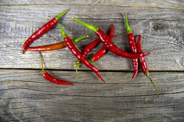 red hot pepper lies on a wooden background