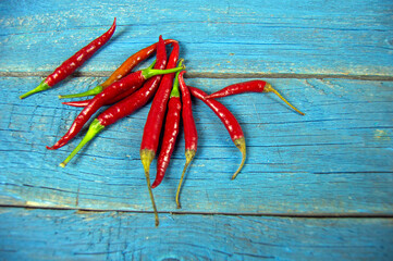 red hot pepper lies on a wooden background