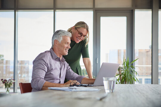 Couple enjoying time together and relaxing with laptop at home