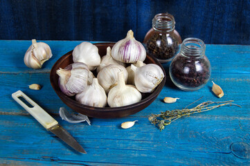 garlic in a clay bowl, spices and herbs