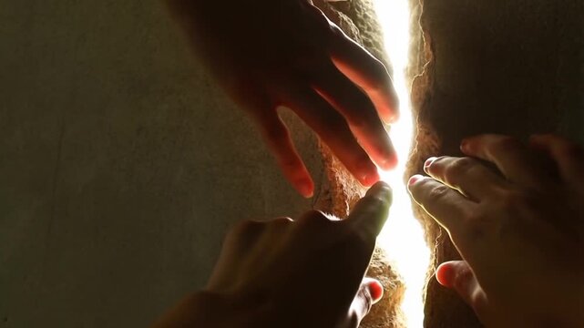 Hands reaching through a crack in a wall, metaphor of comfort zone and emotional connection concept.