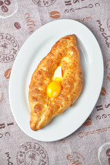 Delicious Georgian Khachapuri on a white plate