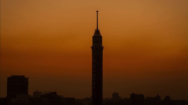 The sun is rising behind Cairo Tower in Egypt