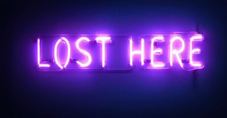 Bright purple neon sign displays words LOST HERE against dark blue wall. Simple, modern aesthetic. Minimalist design evokes feelings.