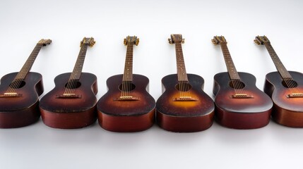 Fototapeta premium Six glossy reddish-brown acoustic guitars aligned in a row against a white background,