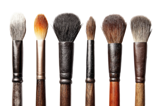 Close-up of several makeup brushes.  Different shapes and colors of brush heads, mounted on wooden handles.  Dark background