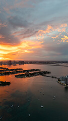 Scenic aerial view of Miami skyline at sunset with fiery skies over Biscayne Bay and islands...