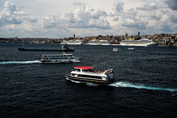 Costa Fortuna cruise ship and other little big ships on the Bosphorus of Istanbul. Ferries and passenger boats are visible cruising the Bosphorus, with large cruise ships in the background. Galata Tow