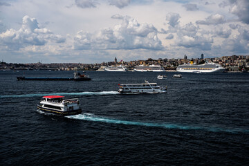 Costa Fortuna cruise ship and other little big ships on the Bosphorus of Istanbul. Ferries and passenger boats are visible cruising the Bosphorus, with large cruise ships in the background. Galata Tow