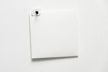 Square white paper sheet on a wall with button. Letter top view. Blank card with paper envelope template mockup