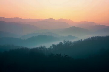 Obraz premium Foggy morning in the mountains with silhouettes of hills.
