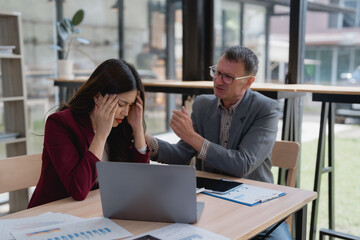 Business people working together, senior manager scolding young businesswoman in office meeting, employee getting headache from being reprimanded by boss