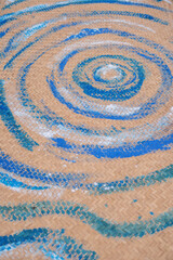 Swirling blue patterns on woven surface