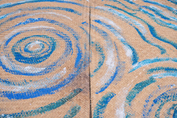 Artistic woven surface with blue and white patterns