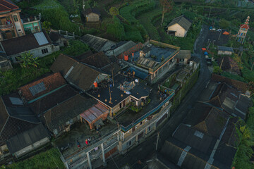 Naklejka premium Aerial view of a rural village with green hills