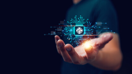 Futuristic concept of artificial intelligence and digital technology. A glowing AI microchip floating above a human hand symbolizes innovation, machine learning, automation and future computing.