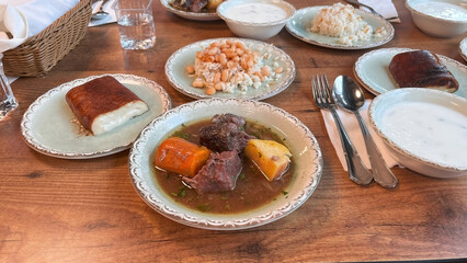 Turkish dishes arranged on a restaurant table. A top view of traditional Turkish dishes served at a restaurant table.