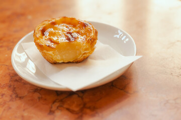 Portuguese egg tart pastry called Pastel de Nata near bakery in Lisbon. Solo tourism and travel