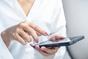 Modern lifestyle concept of woman using smartphone, online internet communication, digital work, and mobile technology in daily life. finger on the screen while texting and browsing social networks.