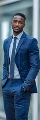 Confident Young Black Businessman in Stylish Blue Suit with Hands in Pockets.