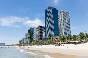 Mother and her son, cute blond boy, playing on the sea, hat, sunglasses, swimsuit, sun protection cream, sea and sand background. Concept: love, lifestyle, children, vacations