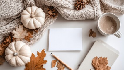 Autumnal flat lay with pumpkins, coffee, and leaves