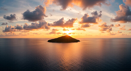 Lone island silhouette at sunset over calm ocean with dramatic clouds water
