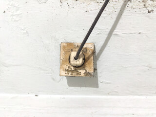 Old Electrical Socket with Cable on White Wall