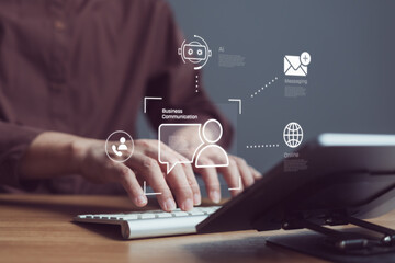 Business professional using keyboard with AI chatbot and messaging icons on virtual interface, for...
