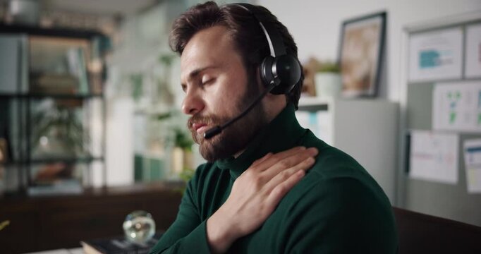 Business, man and neck pain in callcenter with burnout, stiff muscle or pressure at customer service office. Tension relief, massage or stretching with tired consultant, telecom and overworked