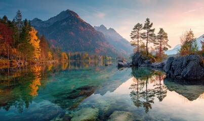 Autumnal mountain lake mirroring sunrise