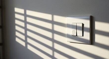 Light switch with fingerprints, white dual-button panel on pale wall marked with subtle smudges, sunlight through blinds casting parallel shadow lines across the surface