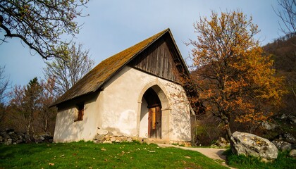 Quaint, weathered chapel nestled in a hillside grove