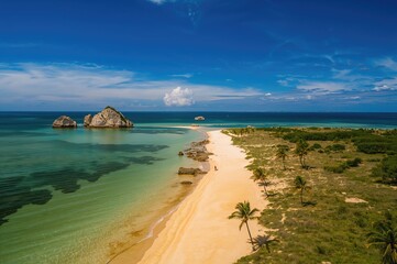 Aerial perspective of a rocky shoreline with clear emerald waters
