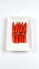 Red chili peppers on a white plate