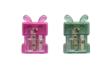 Two pink and green pencil sharpeners on a white background