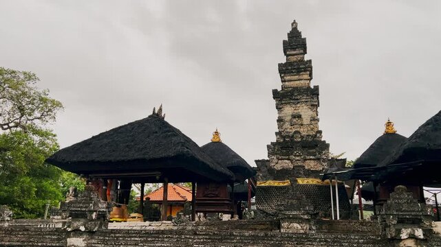 Beautiful Balinese temple adorned with statues and stone carvings stands as a spiritual offering place highlighting timeless cultural devotion and traditional artistry of Bali.