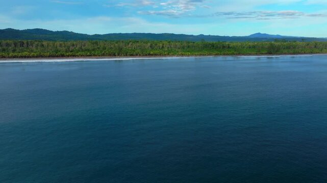 Untouched remote pristine coastline waves Cape Wom Dogreto Bay Harbor View Papua New Guinea PNG aerial drone Madang Wewak Kavieng Vanimo Tufi sunny blue sky tropical beach shoreline forward pan up