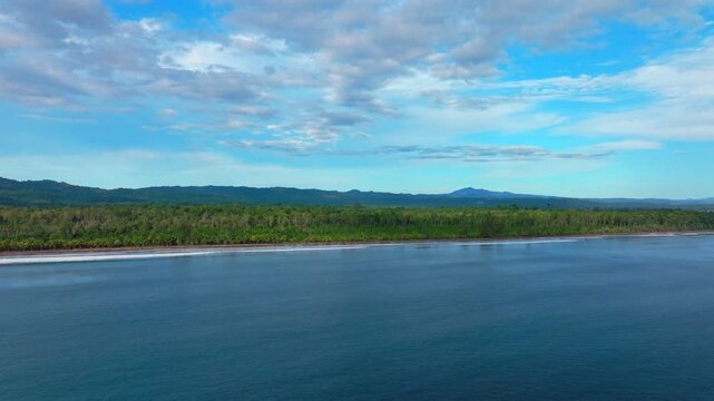 Untouched remote pristine coastline waves Harbor View Papua New Guinea PNG aerial drone Cape Wom Dogreto Bay Madang Wewak Kavieng Vanimo Tufi sunny blue sky tropical beach shoreline downward motion