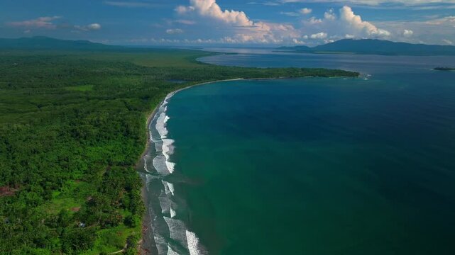 Untouched remote pristine coastline waves Cape Wom Yuo Mushi Island Papua New Guinea PNG aerial drone Madang Wewak Kavieng Vanimo Tufi sunny bluesky tropical beach shoreline East Sepik Province circle