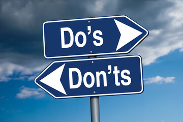 Two blue directional road signs showing do's and don'ts against cloudy sky choice decision