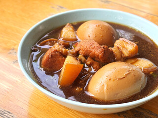 Close-up Boiled Eggs in Sweet Brown Soup or Five-Spice Egg in a small bowl with natural light, or called  Kai Paloh in Thai language. One of healthy Asian food.