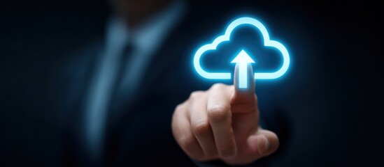 A hand in a suit points at a glowing blue cloud with an upward arrow on a dark background, symbolizing cloud computing and data